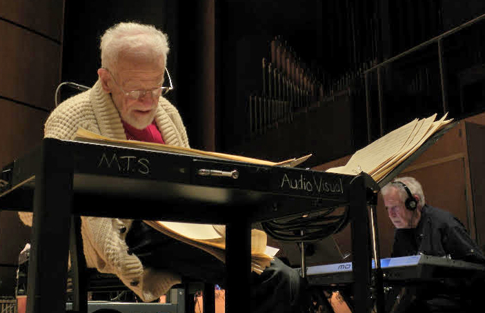 Gerry checks his music score while Dave Grusin prepares a keyboard coloration for the score.